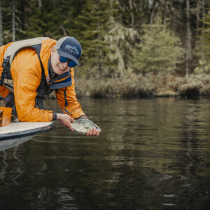 A man holding a fish on a boat